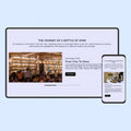Computer monitor and smartphone displaying a wine-themed website on a light blue background